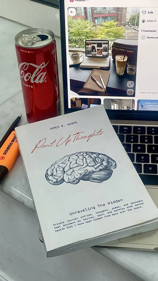 Pent Up Thoughts paperback by James B. Agape styled with a Coca-Cola and highlighter on a marble desk, poetry for anxiety and healing